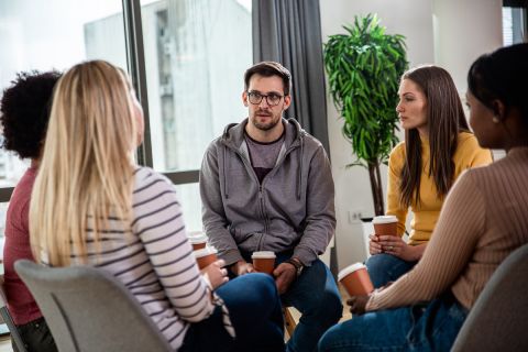 people sitting in circle in sober living home